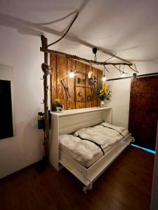 a white bed with a canopy in a room at FeWo Almherzl mit Hallenbad,Sauna,Panoramablick,renoviert in Missen-Wilhams