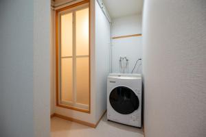 a washer and dryer sitting in a room at KAMUI Stay in Asahikawa +78 photos