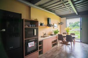 a kitchen with a sink and a table with chairs at LiJu's House - Access to Hanoi Centre, Full Kitchen in Hanoi