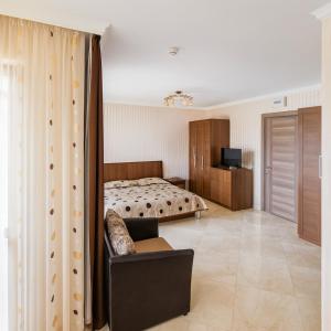 a bedroom with a bed and a couch and a television at Romantic Studio Florence in Sveti Vlas +27 photos