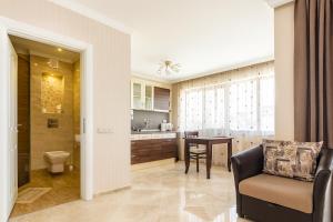 a kitchen and living room with a couch and a table at Romantic Studio Florence in Sveti Vlas