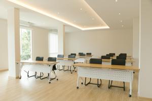 a conference room with desks and chairs in it at M Hotel Kanchanaburi in Ban Chuk Kum