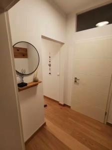 a hallway with a white door and a mirror at Gemütlich wohnen mit Weinblick in Horrweiler +8 photos