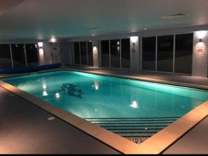 a swimming pool in a building at night at Northern Lights in Lossiemouth