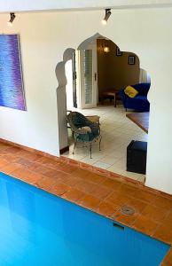 a house with a swimming pool with a table and a chair at Sunny Shore B&B in Dar es Salaam +53 photos