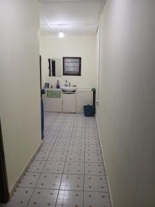 a bathroom with a sink and a tiled floor at Quiet and Secure House, Hohoe in Hohoe
