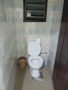 a white toilet in a bathroom with a mirror at Quiet and Secure House, Hohoe in Hohoe