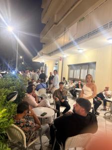 a group of people sitting in chairs in a room at Hotel CARLO in Riccione