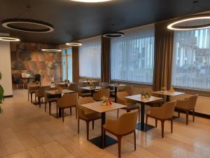 a restaurant with tables and chairs and large windows at Hotel am Asenberg - Bad Salzuflen - nähe Messe, schnelles WLAN, freie Parkplätze, in Bad Salzuflen
