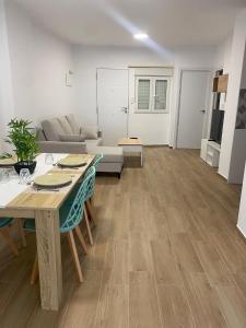 a living room with a table and a couch at PET FRIENDLY Casita Marín in Santa Pola