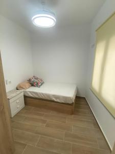 a small room with a bed and a light at PET FRIENDLY Casita Marín in Santa Pola