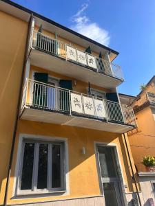 a building with a balcony with clocks on it at San Pietro Pontremoli in Pontremoli