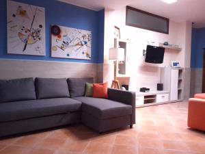 a living room with a couch and a tv at SantuMasi Bed & Breakfast in Gallipoli