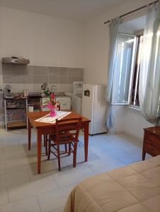 a kitchen with a table and a kitchen with a refrigerator at Testaccio Immobiliare in Rome +17 photos