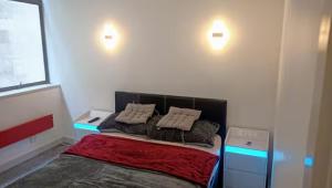 a bedroom with a bed with two pillows on it at GORGEOUS FlatE Central London Liverpool St Station in London +26 photos