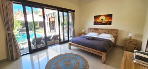a bedroom with a bed and a view of a pool at 3-bedroom Villa Alanta in Sanur in Sanur