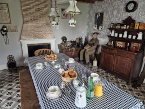a table with a blue and white checkered table cloth at Auxais memory 44' in Auxais