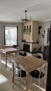 a kitchen with two tables and chairs in a kitchen at Willa Ewa in Międzyzdroje