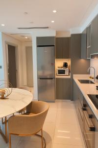 a kitchen with a table and a refrigerator at Best Emaar Beachfront view one bedroom in Dubai