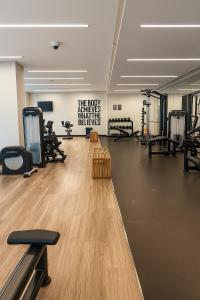 a gym with treadmills and a sign on the wall at Best Emaar Beachfront view one bedroom in Dubai