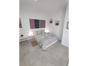 a bedroom with a bed and two pictures on the wall at Fantastico 4 - with large private terrace, free parking, air conditioning, BBQ in Puerto de la Cruz +16 photos