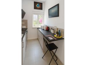a small kitchen with a counter and a table at Fantastico 4 - with large private terrace, free parking, air conditioning, BBQ in Puerto de la Cruz