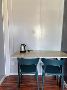 a table and two chairs in a room at Roomstay Kontena Sungai Bioh in Gua Sai