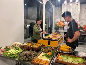 a man and a woman preparing food at a buffet at Sapa Villa Florence in Sapa +92 photos