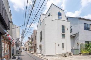 a white building on the side of a street at 夢の宿 東中野 134t in Tokyo