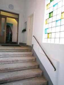 a woman walking down a staircase with a stained glass window at Nr 10 Modernes helles Ferienzimmer für vier Personen familienfreundlich mit gemeinsamer Dusche in Annaberg-Buchholz +4 photos