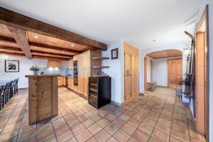 a kitchen with wooden cabinets and a island in a room at Ride Inn Verbier - B&B - private room and ensuite bathroom in Verbier +11 photos