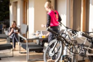 a woman walking in a room with bikes parked at Ride Inn Verbier - B&B - private room and ensuite bathroom in Verbier