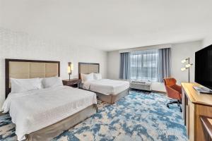 a hotel room with two beds and a flat screen tv at Hampton Inn & Suites Kenosha Pleasant Prairie in Kenosha +33 photos