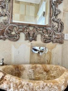 a bath tub in a bathroom with a mirror at Keiraleagh House in Wollongong