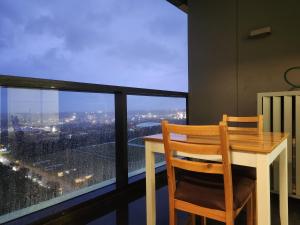 a table and chairs on a balcony with a view at Skyline Comfort - Sydney Olympic Park in Sydney