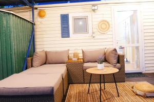 a small patio with a couch and a table at Seaside Garden Galaxidi in Galaxidi