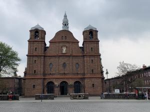 a large brick building with a clock tower at Zacisze Pod Nikiszem in Katowice