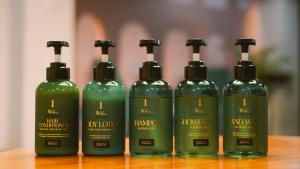 a group of four green bottles sitting on a table at ELIVAAS 1 BHK with Jacuzzi & Lift - Kamerios Brisa in Goa +58 photos