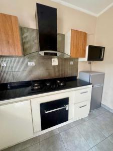 a kitchen with a stove and a counter top at Luxury 3 Bedroom Terrace House in Lekki Phase 1 24hr light & Security in Lekki