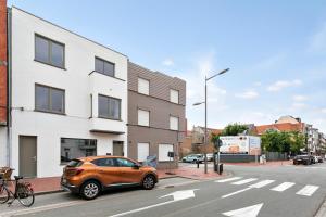 an orange car parked on the side of a street at Spacious terraced house, center of Knokke in Knokke-Heist