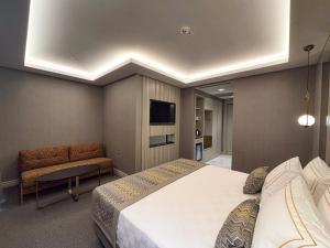 a bedroom with a large bed and a tv at Saygın Beşiktaş in Istanbul