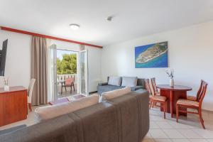 a living room with a couch and a table at Apartments Vila Kristina in Baška Voda