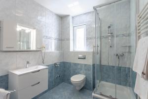 a bathroom with a toilet and a glass shower at Apartments Vila Kristina in Baška Voda +66 photos