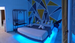 a bedroom with a bed with a blue wall at Boulitos 1 in Kavos
