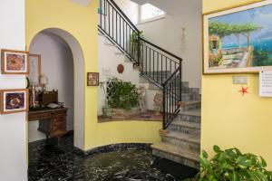 a hallway with a stairway and a stream of water at Hotel Villa Degli Aranci in Maratea