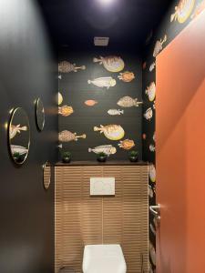 a bathroom with a toilet and a wall with planets at Gîte de luxe in Leimbach +7 photos