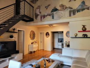 a living room with a white couch and a staircase at Luxury apartment in Florence in Florence