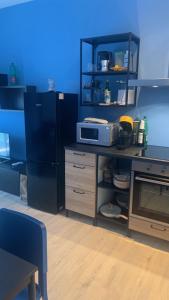 a kitchen with a black refrigerator and a microwave at Appartamento Espero in Gabicce Mare +6 photos