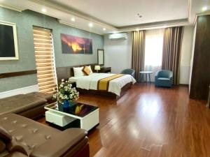 a hotel room with a bed and a couch at NASA Hotel in Bồ Sơn