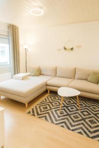 a living room with a couch and a table at Dein Ferienhaus in Andernach